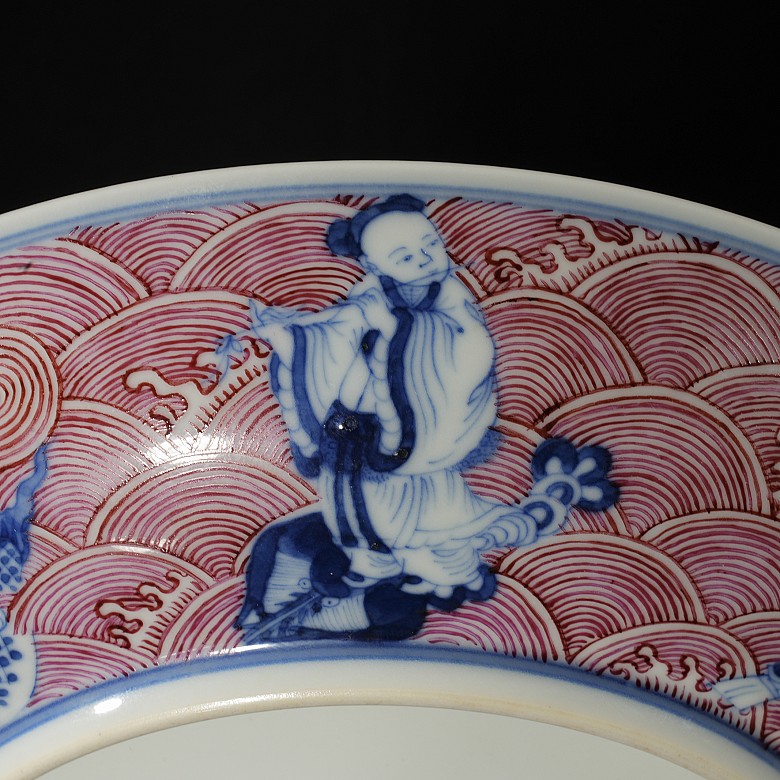 Porcelain plate in red, blue and white ‘The Eight Immortals’, with Qianlong trademark