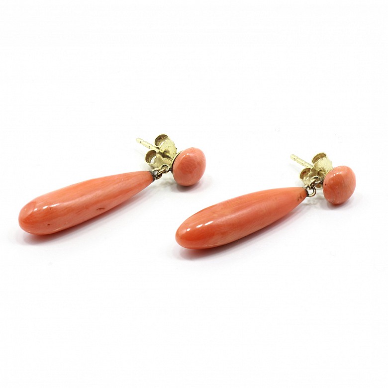 Pair of coral earrings set in 14k yellow gold.