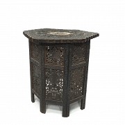 Carved wood table with a base, 20th century