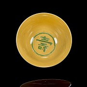 Porcelain enamelled bowl with yellow background ‘Dragon’, with Qianlong seal