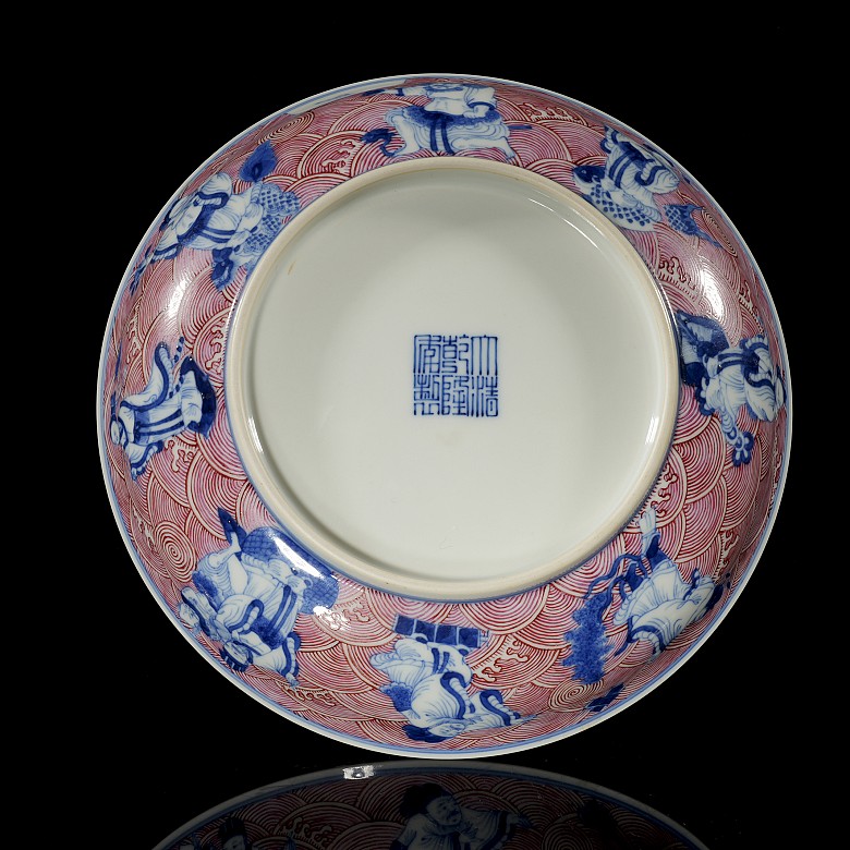 Porcelain plate in red, blue and white ‘The Eight Immortals’, with Qianlong trademark