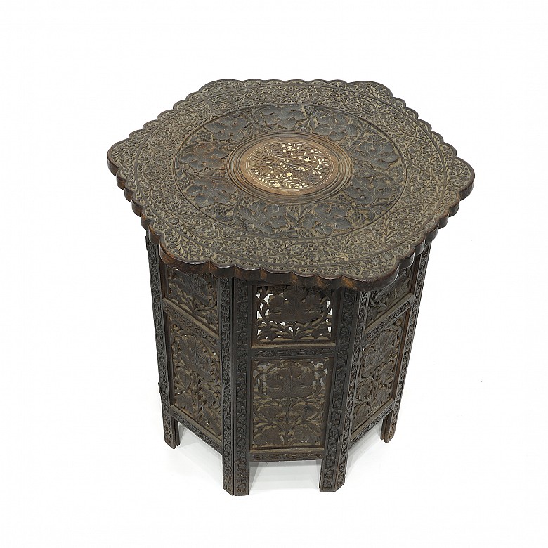 Carved wood table with a base, 20th century