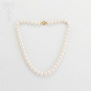 Pearl 9-10mm with 18k yellow gold clasp.