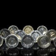 Colección de doce platos pequeños de plata