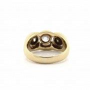 18k gold ring with three diamonds.