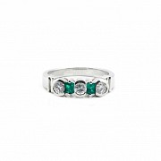 Diamond and emerald ring set in 18k white gold.