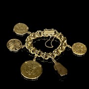 Gold bracelet with coins and charms