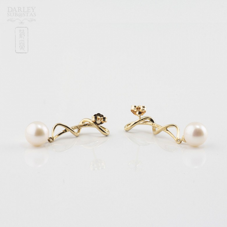 Long earrings with pearls in 18k yellow gold and diamonds.