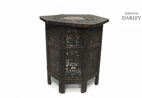 Carved wood table with a base, 20th century