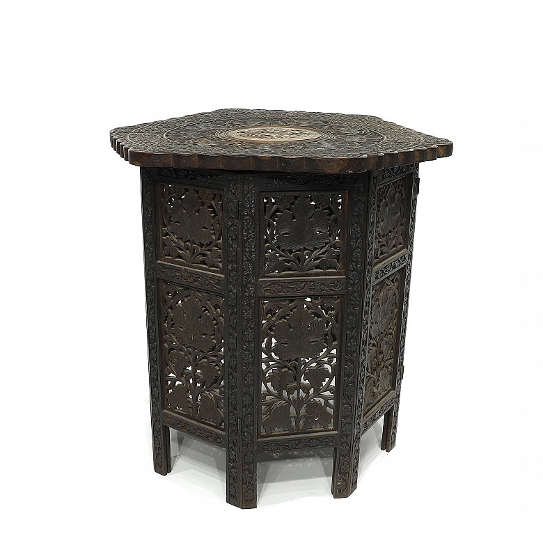 Carved wood table with a base, 20th century