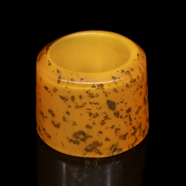 Orange glass archer's ring with gold leaf shavings, 20th century