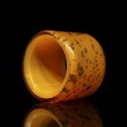 Orange glass archer's ring with gold leaf shavings, 20th century