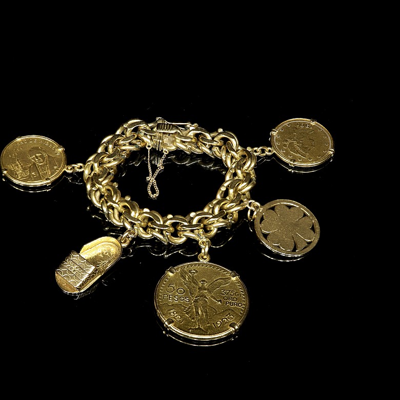 Gold bracelet with coins and charms