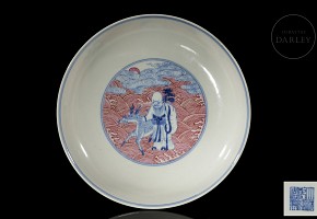 Porcelain plate in red, blue and white ‘The Eight Immortals’, with Qianlong trademark