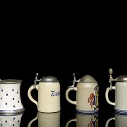 Four earthenware beer steins, 20th century