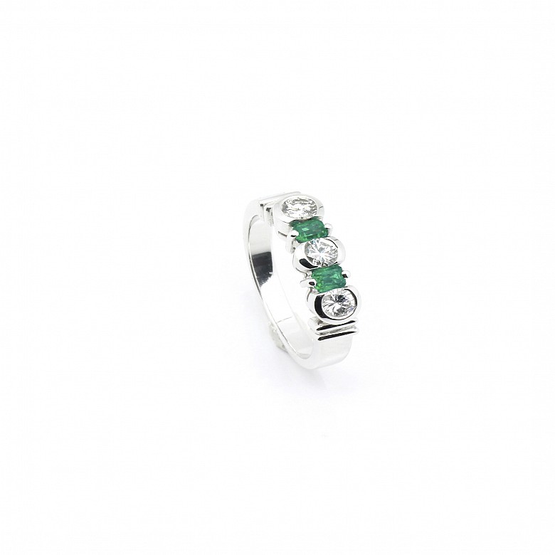 Diamond and emerald ring set in 18k white gold.