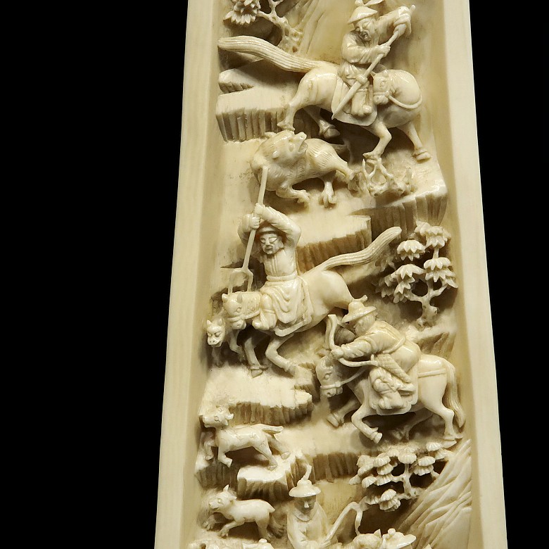 A carved ivory wrist rest, 19th century