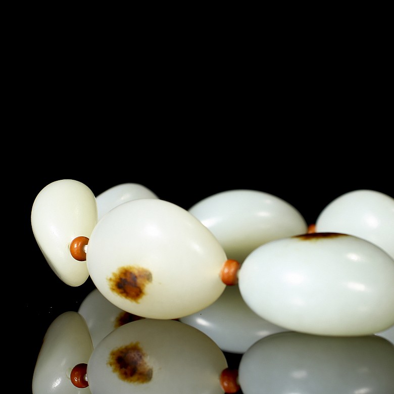 Bracelet of nine carved jade beads, 20th century