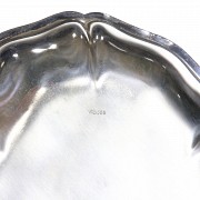 Silver tray with wavy edge.