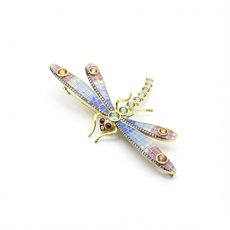 Elegant brooch in the shape of a dragonfly set with precious gems.