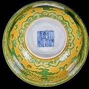 Porcelain enamelled bowl with yellow background ‘Dragon’, with Qianlong seal