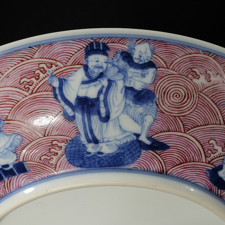 Porcelain plate in red, blue and white ‘The Eight Immortals’, with Qianlong trademark