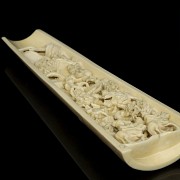 A carved ivory wrist rest, 19th century