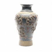 Chinese ceramic vase with relief dragons and blue ground.