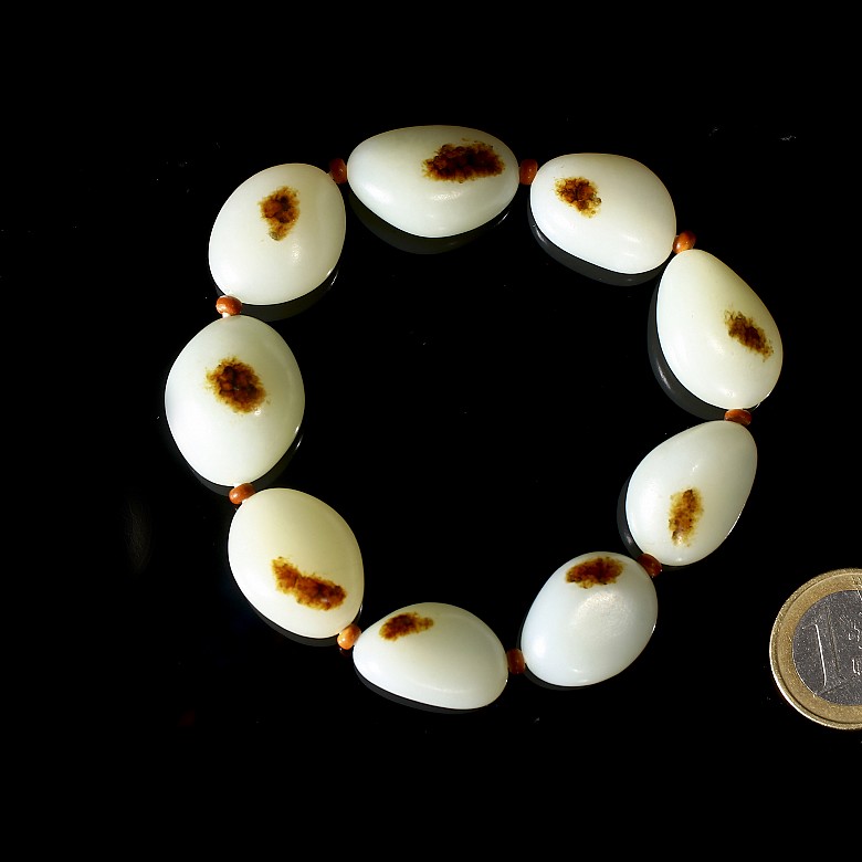 Bracelet of nine carved jade beads, 20th century