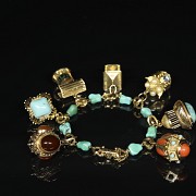 Yellow gold bracelet with pendants and coloured stones