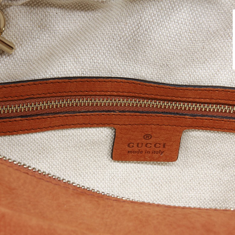 Gucci women's orange leather bag.