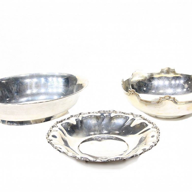 Three small silver trays.