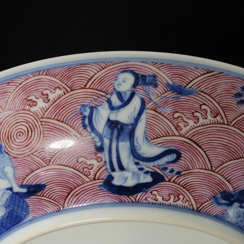 Porcelain plate in red, blue and white ‘The Eight Immortals’, with Qianlong trademark