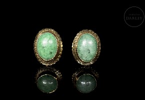 Gold earrings with green gemstone