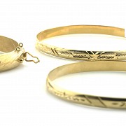 Lot of three bracelets in 18k yellow gold