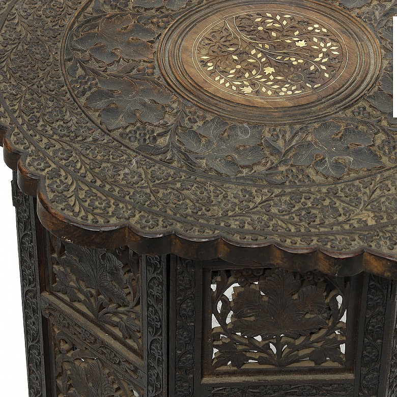 Carved wood table with a base, 20th century