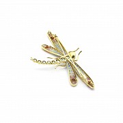 Elegant brooch in the shape of a dragonfly set with precious gems.