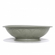 A Yue-style ceramic dish with a celadon glaze.