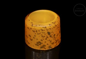 Orange glass archer's ring with gold leaf shavings, 20th century