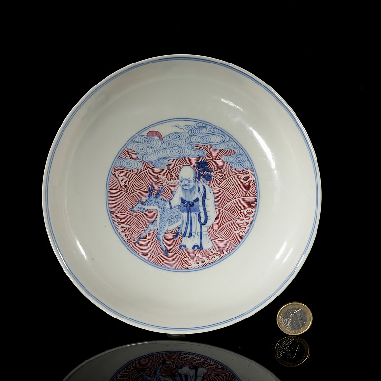 Porcelain plate in red, blue and white ‘The Eight Immortals’, with Qianlong trademark