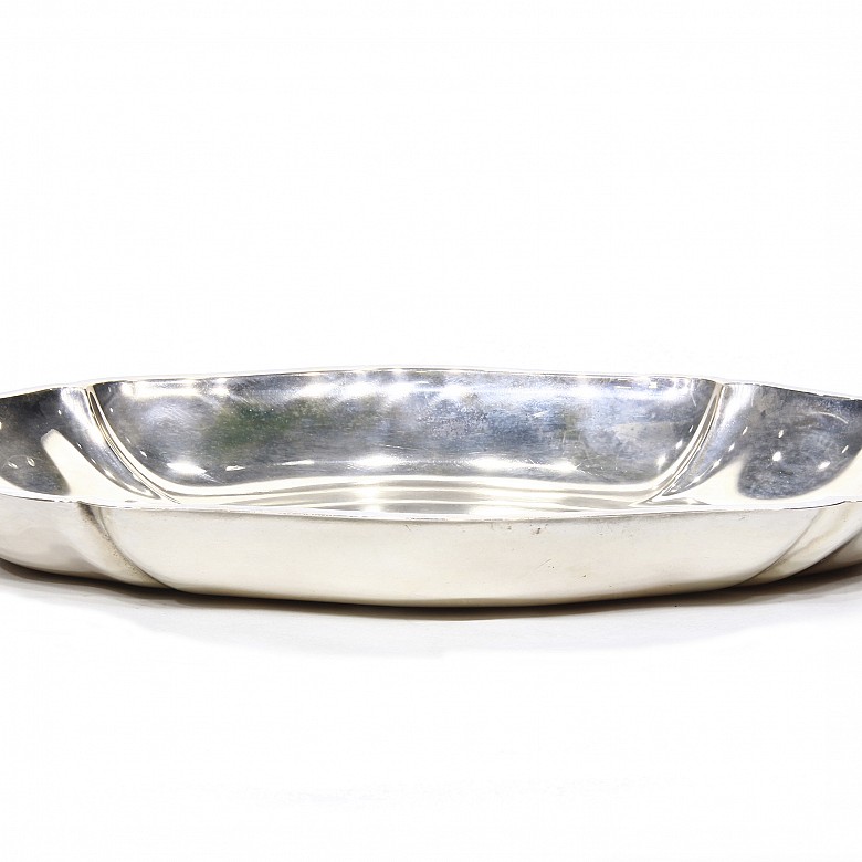 Silver tray with wavy edge.