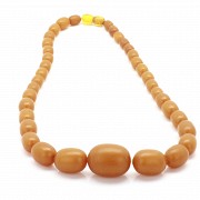 Necklace with diminishing amber beads.