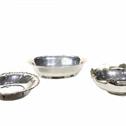 Three small silver trays.