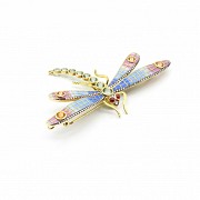 Elegant brooch in the shape of a dragonfly set with precious gems.