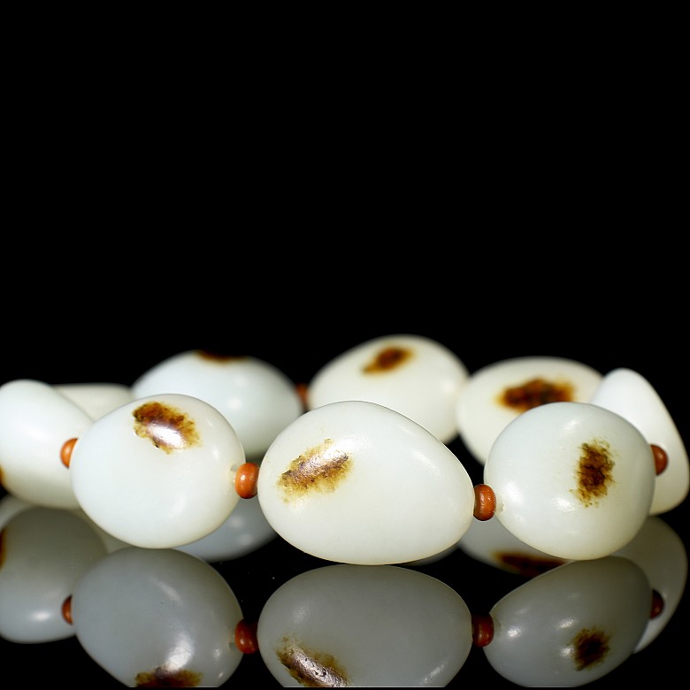 Bracelet of nine carved jade beads, 20th century